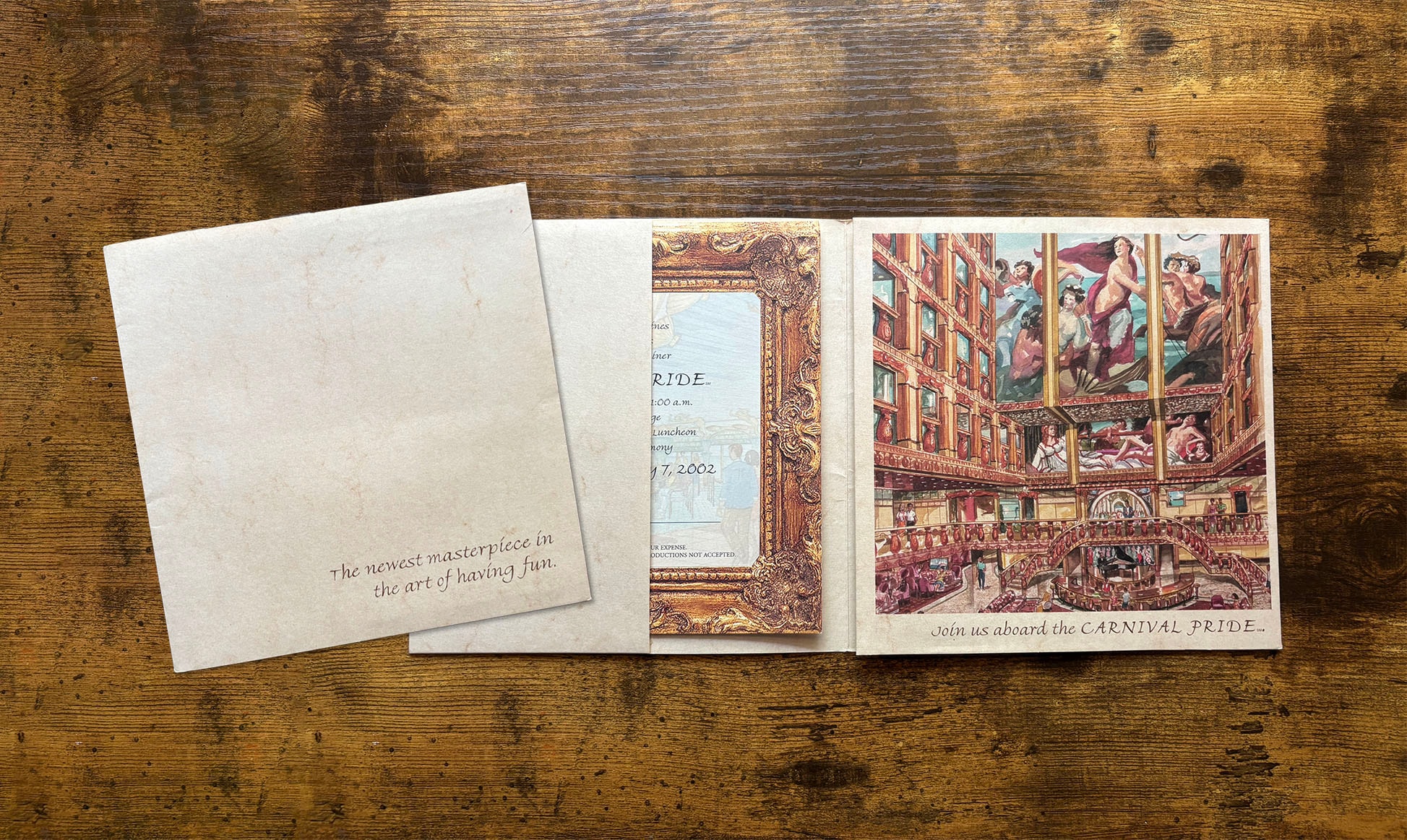 Carnival Pride invitation cover with envelope open on wooden surface