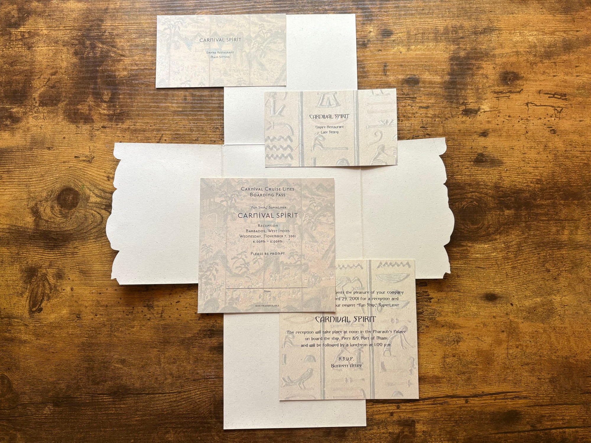All Carnival Spirit invitation pieces laid out showing boarding pass, dinner cards and invitation