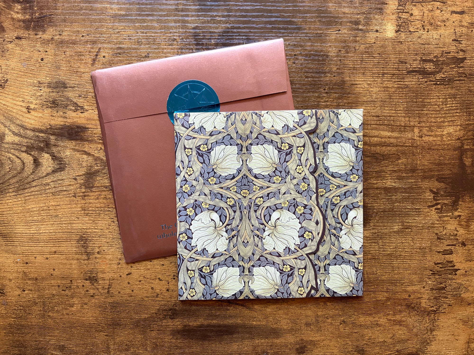 Carnival Spirit invitation cover with ornate floral patterned envelope and teal wax seal